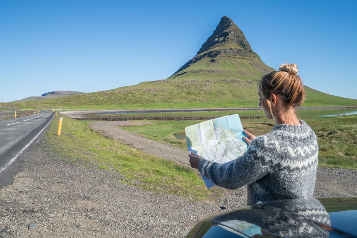 Woman on her way to Kirkjufellsfoss mountain while visiting Snaefellsnes Peninsula