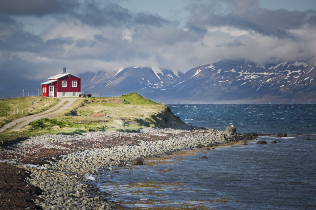Westfjords in Iceland. Red house against the coast