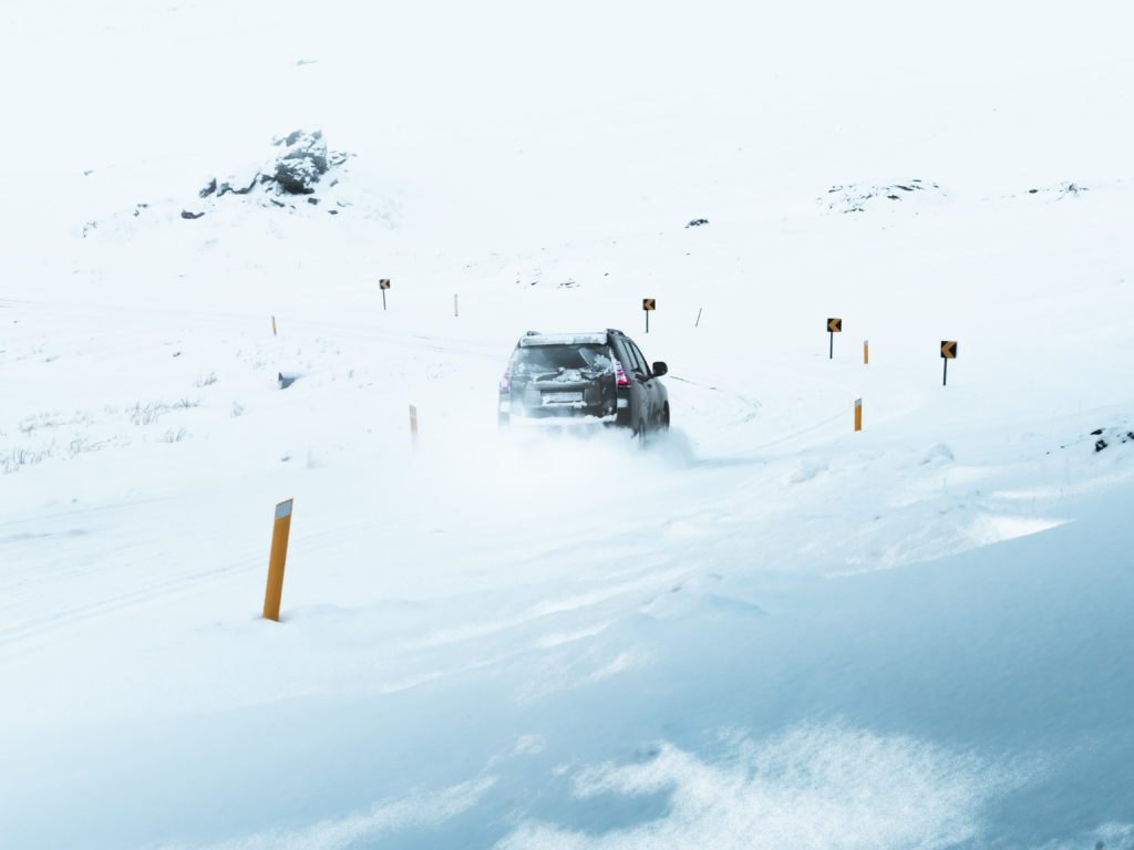 Driving in snow during winter in Iceland.